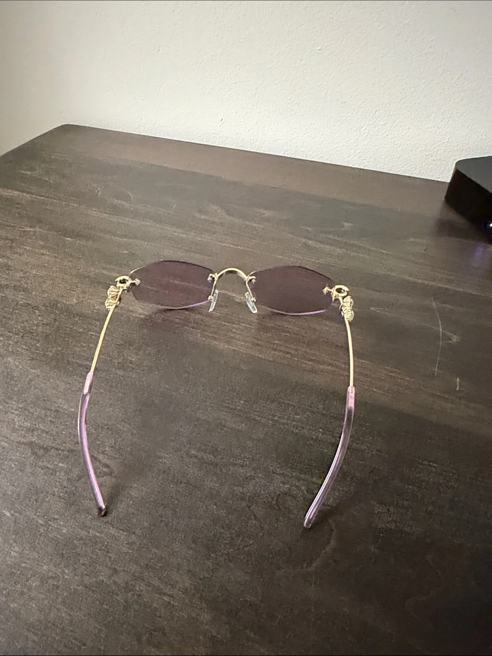 Elegant Rimless Women's Sunglasses with Gold Accents - Purple Lenses